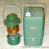 Coleman twin mantle white gas lantern Model 220E, date coded 1961. Globe is amber tinted. Comes with