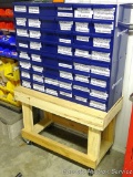 Steel drawer bank with 48 drawers, plus contents and rolling stand. Drawer bank is approx. 3' x