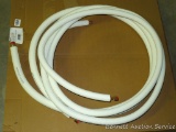 Two lengths insulated refrigerant line, each around 15'. Marked 1/4 x 1/2 and 1/2 x 1/2 25/50.