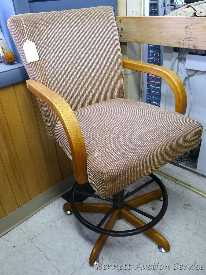 Upholstered swivel chair is 23" x 24" x 44" tall overall. Appears in good condition. Matches 328.