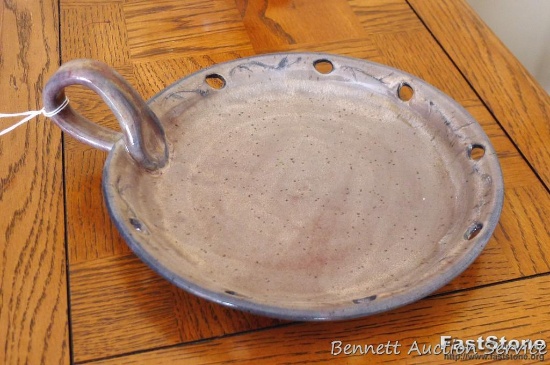 Nice stoneware handled dish is signed 'A. Knutson', measures approx 9" across without handle.
