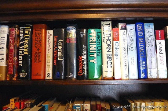 Shelf of books incl. The Covenant, Take Me Home, The Thorn Birds, Centennial and more.