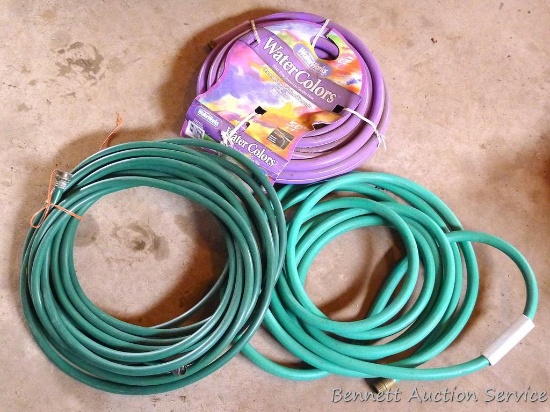 One new, two used garden hoses.