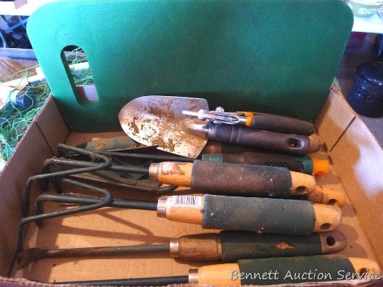 Garden tools and a kneeling pad.
