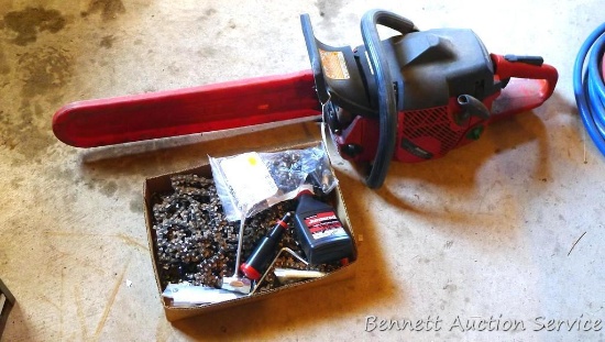 Jonsered CS2159C chainsaw with 18" bar and a box of extra chains, more. Saw turns over and has