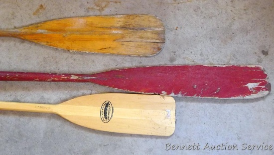 Two canoe paddles, one look in like new condition; boat oar 78" long.