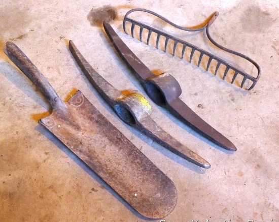 Two pick heads, tree spade head, dirt rake head.