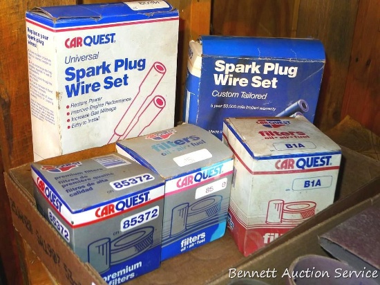 Three oil filters, a spark plug wire set, and a partial wire set.