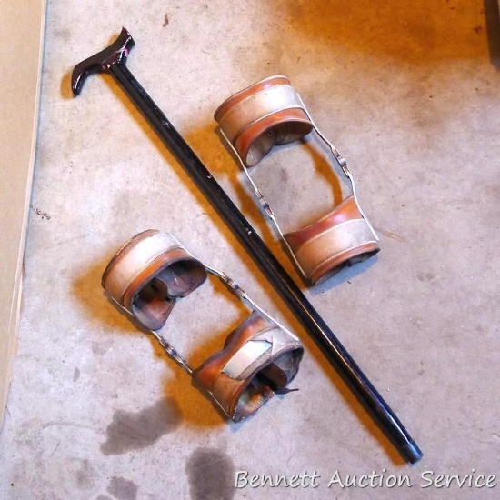Leather and metal knee braces are old enough to decorate with. 34" cane has a slightly loose handle.