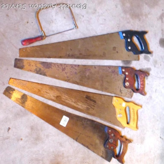 Four carpenter's cross cut saws approx. 29", plus a rusty coping saw.