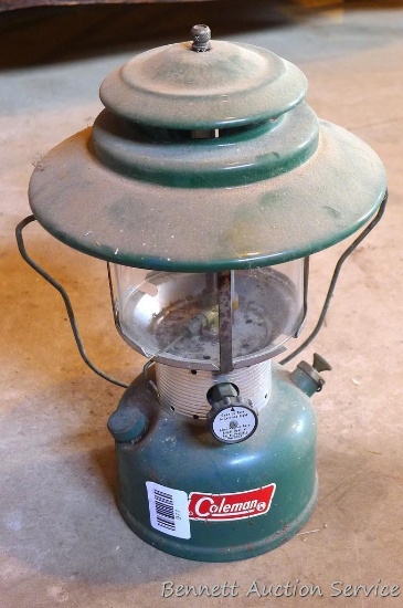 Coleman Model 228F white gas lantern is complete and in overall good condition. Bottom is dated