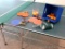 Ping pong table with accessories including paddles, extra net, ping pong balls. Table measures 5' x