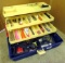 Three shelf tackle box filled with archery supplies including broad heads, feathers, nocks,