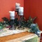 Wrought candle holders, candles, table runner and greenery. Display as pictured is approx. 6' wide.