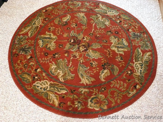 Wilshire 62" diameter area rug matches Lot 1023. Rug is in great shape, pretty pattern.