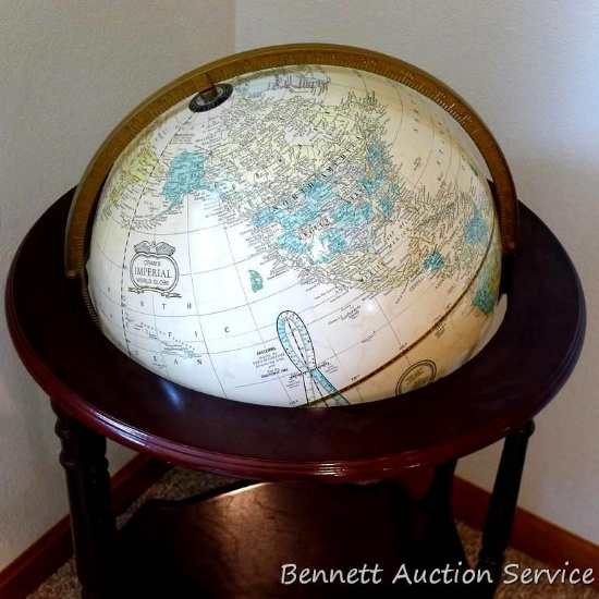 Cram's Imperial World globe with magazine or book holder incorporated into stand. 38" high and