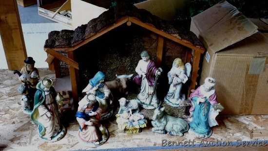 Beautiful Nativity set with manger. Standing pieces are each approx. 9" tall. Eleven ceramic pieces