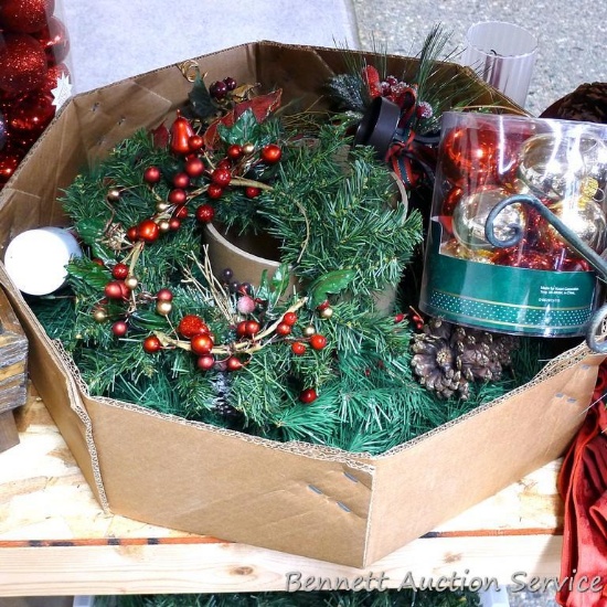 Christmas decorations including 22" wreath, ornaments, tote of greenery, wooden table display is
