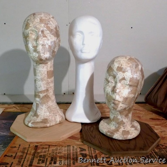 Three foam mannequin heads - two have been decoupaged and mounted loosely on bases. Tallest is 18".