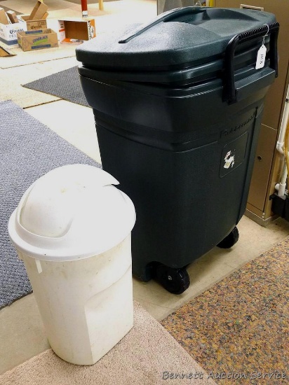Rubbermaid wheeled garbage tote with handle and lid, plus another garbage can. Rubbermaid can is 36"