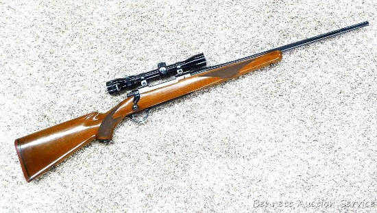 Ruger M77 bolt action rifle in .30-06 has a 2-7 scope. Rifle shows plenty of handling marks on wood