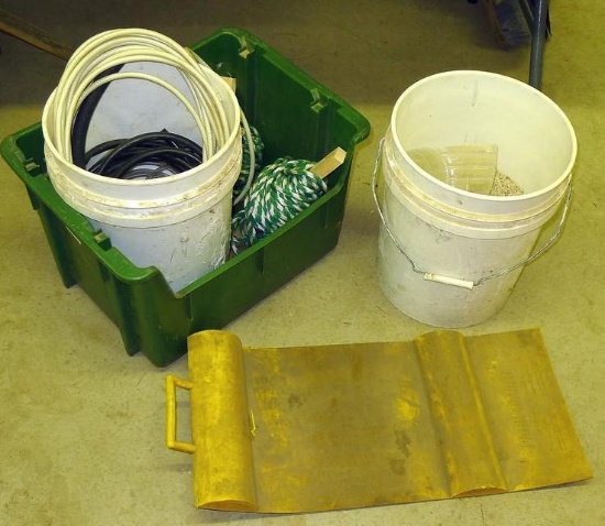 Half a bucket of floor dry; 5 gallon pail with assorted tubing; 3/8" rope; bin 15" x