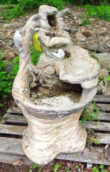 Concrete garden fountain stands about 39" tall and is in good shape. Currently resting on a pallet