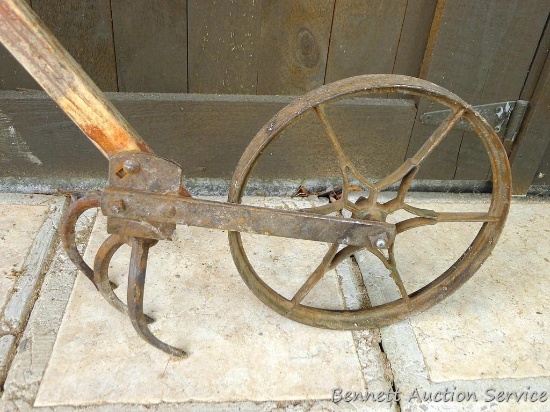 Antique garden tiller will make a nice display piece.