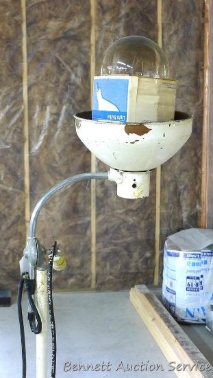 Drywall mudding light with swiveling head has a cast iron base is 70" tall. Cord is taped.