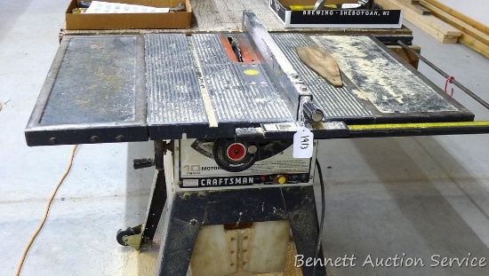 10" Sears Craftsman table saw with attached table. Saw includes a metal frame with wheels, platform