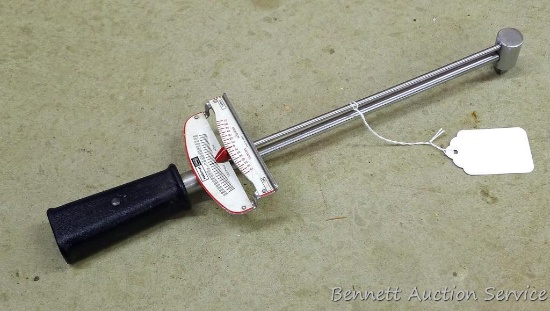 Craftsman torque wrench is 16" long. Measures up to 600 inch pounds. Has 3/8" drive.