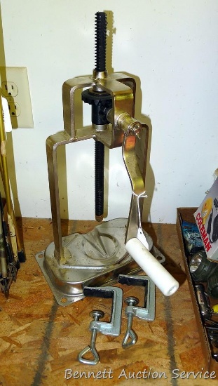 Most or all of a hand driven press, stands 18" as pictured. Includes 2 clamps.