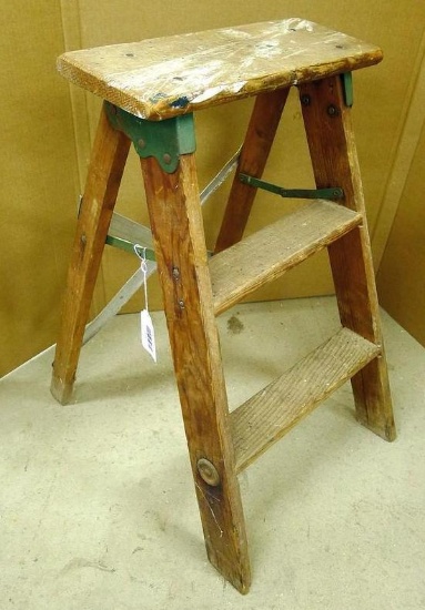Wooden step stool is 23" tall.
