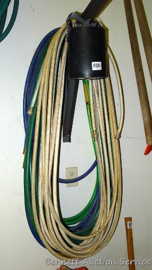 4 Garden hoses of various lengths and a pocket hose.