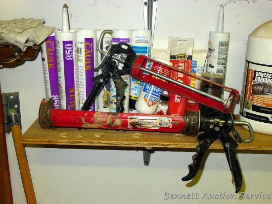 Large and regular caulking guns with a partial tube of ceramic tile caulk, more.