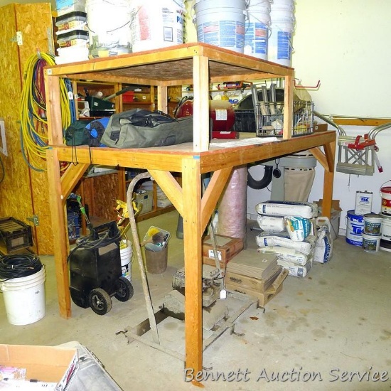 Heavy duty homemade shelf unit made out of 2x4s and chip board is 4' x 8' x 69" tall.