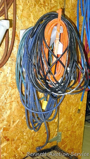 4 Lengths of electrical cords of various lengths, one incl a trouble light.