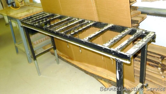 Metal stand with adjustable legs has ball bearing rollers is 55" long x 16" wide x 36".