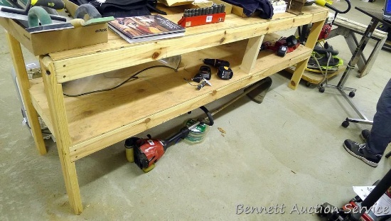 Homemade work bench with lower shelf framed with 2x4 lumber is 24" x 98" x 35".