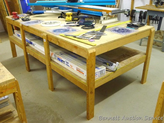 Heavy duty homemade work table with lower shelf framed with 2x4 lumber is 48" x 98" x 35".
