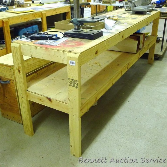 Homemade heavy duty work table with lower shelf framed with 2x4 lumber is 24" x 98" x 35".