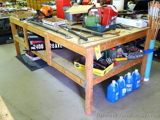 Homemade heavy duty wooden work table with lower shelf is 4' x 8' x 35" tall.  Please come later on