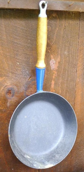 LeCreuset #24 cast iron frying pan with blue enamel coating.