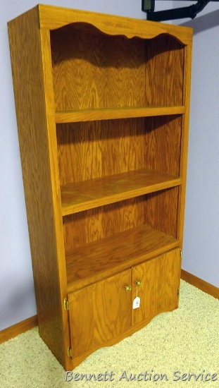 Bookcase with lower storage cabinet. Measures 64" high x 32" wide x 13" deep.