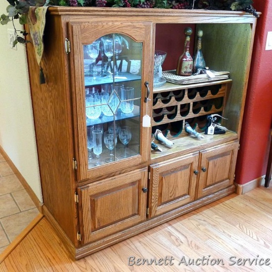Lighted wine cabinet has been revamped from a nice solid wood entertainment center. Has glass