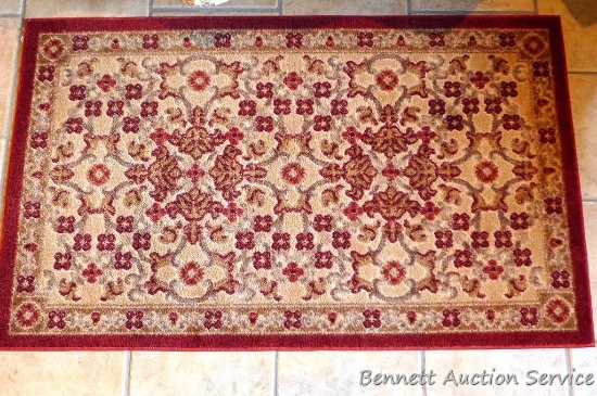 Pretty rubber backed area rug measures 30" x 50".