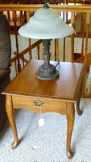 Solid wood end table with 22" tall table lamp. Both pieces are in good condition. Table has a drawer