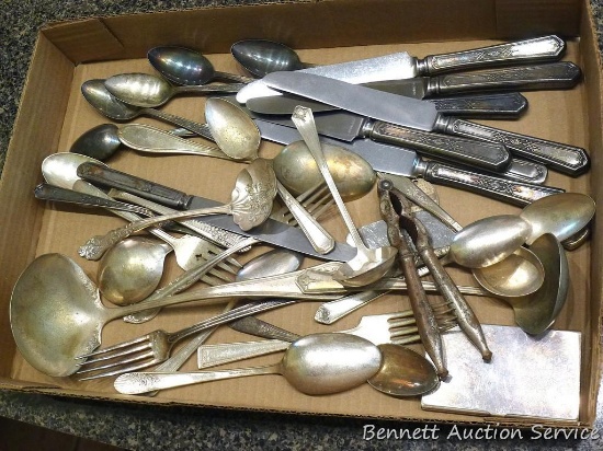 Variety of silver plated flatware including servers, forks, knives, spoons. Largest piece is a ladle
