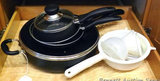 12" T-Fal skillet with lid, other matching pans; a few funnels and a colander.