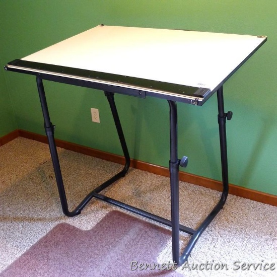Drafting table with office chair mat. Smaller table measures 30" x 42" and is currently set at 41"
